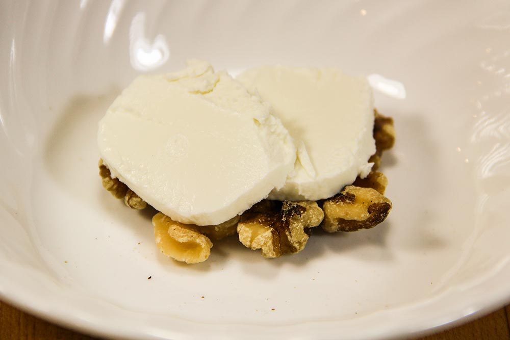 Goat Cheese on Top of Shelled Walnuts in Bowl