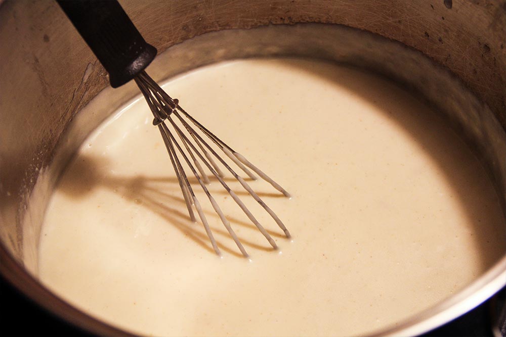 Melting Cheese and Stirring With Whisk