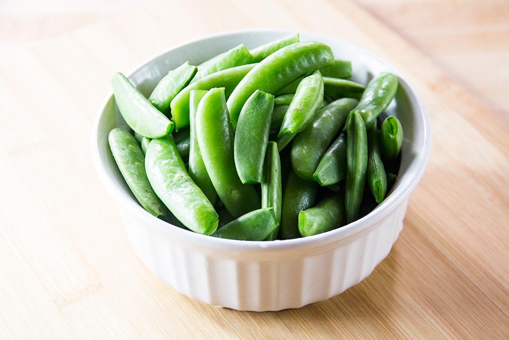 Sugar Snap Peas in Bowl on Cutting Board