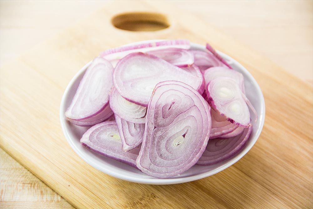 Sliced Shallots on Cutting Board