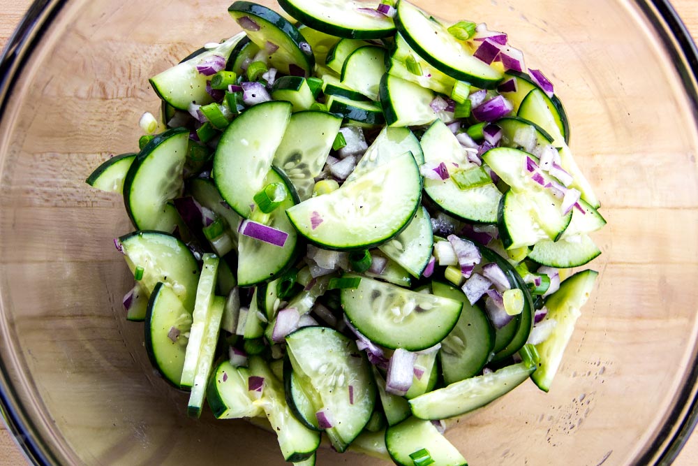 Mixing Sliced Cucumbers