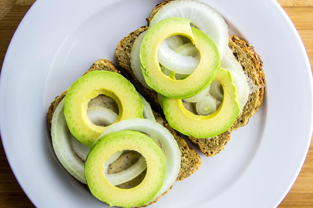 Adding Avocado Slices to Sandwich