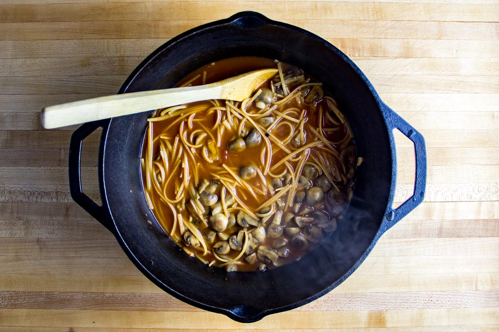 Adding Linguine, Broth & Tomatoes to Dutch Oven