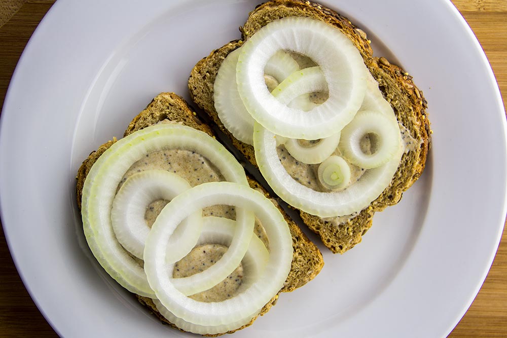 Adding Onion Slices to Sandwich