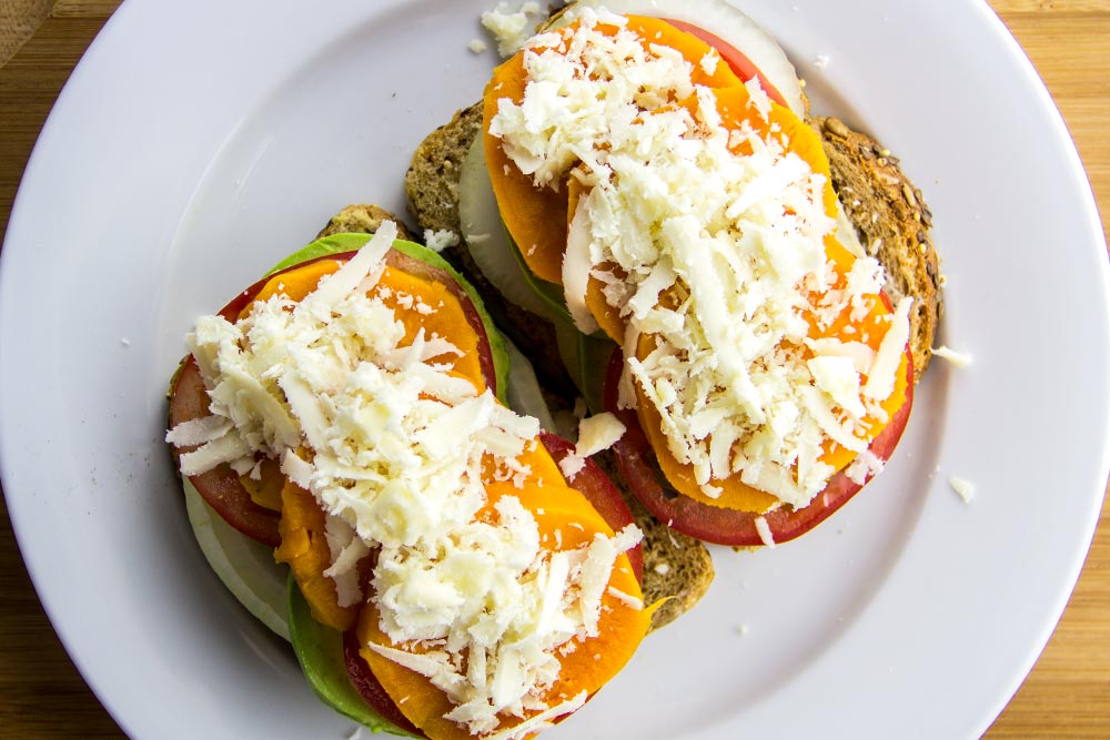 Adding Shredded Monterey Jack Cheese to Sandwich