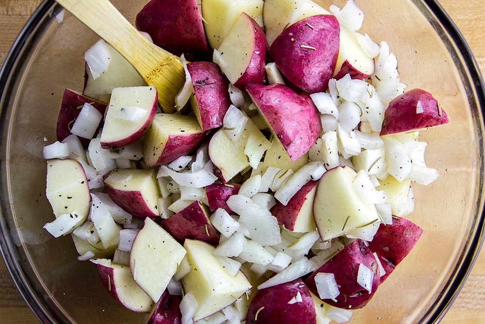 Chopped Sweet Onion & Quartered Red Potatoes in Large Glass Bowl