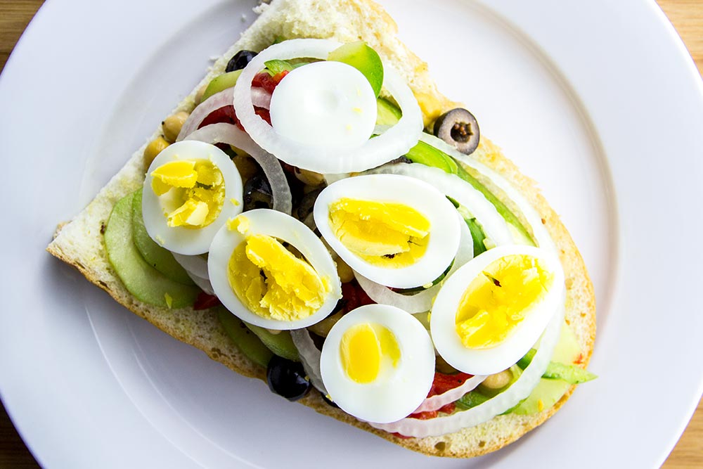 Adding Hard-Boiled Egg Slices to Sandwich