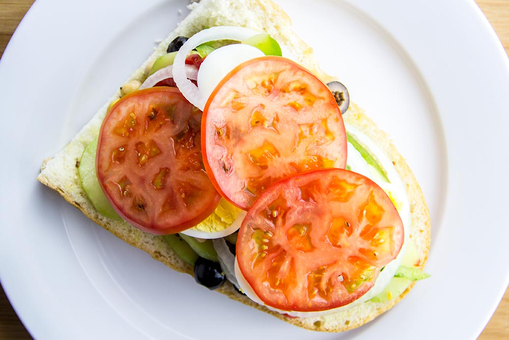 Adding Tomato Slices to Sandwich
