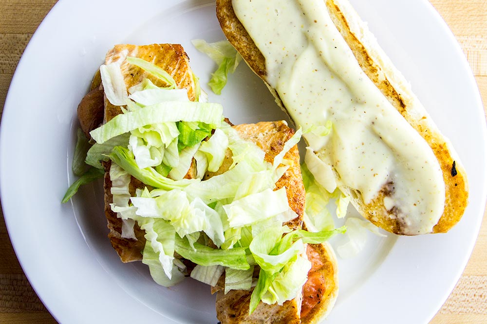 Adding Lettuce to Salmon Sandwich