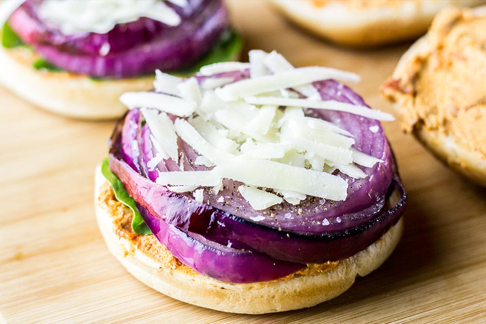 Adding Shredded Asiago Cheese to the Portobello Burger