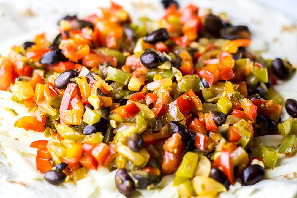 Adding Vegetable Filling to Tortilla