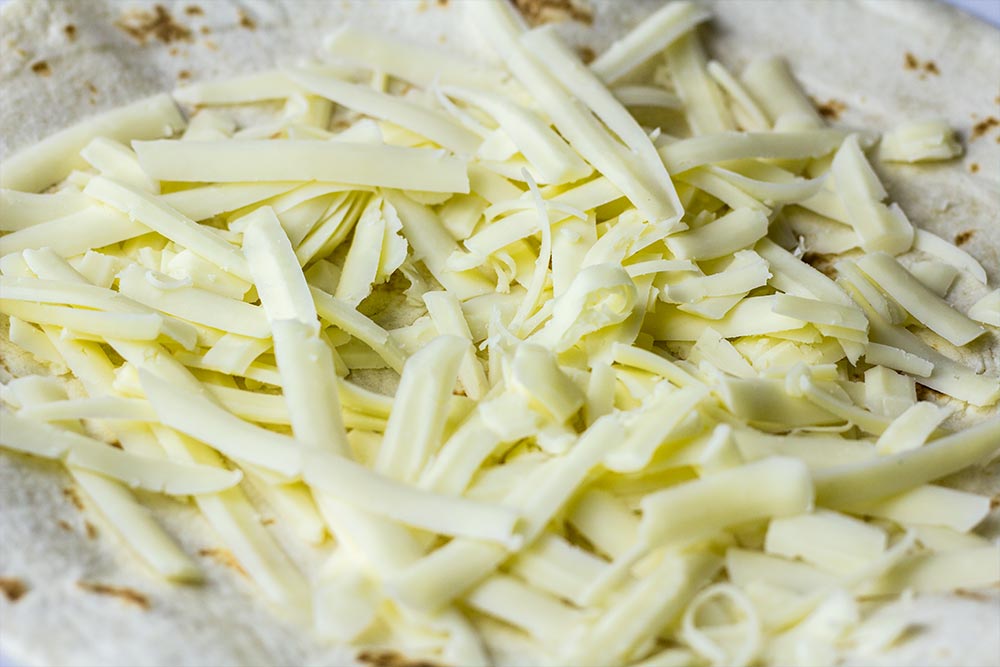 Shredded Monterey Jack Cheese on Tortilla
