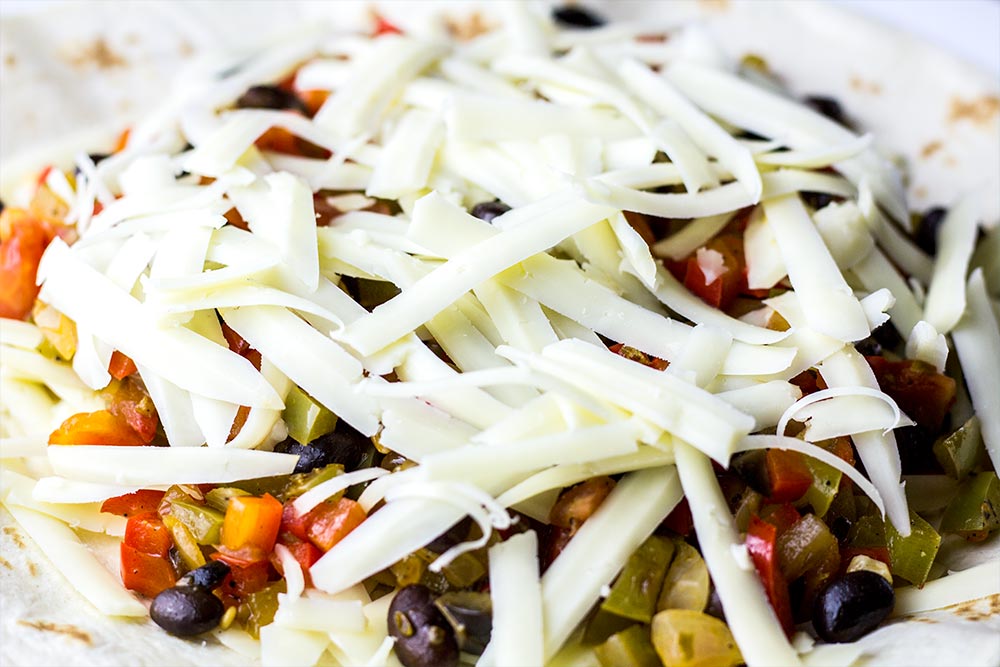 Topping the Vegetable Filling with Shredded Monterey Jack Cheese