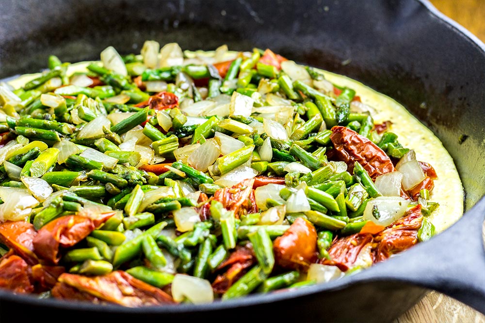 Adding Asparagus & Onion to an Omelet in a Cast Iron Skillet