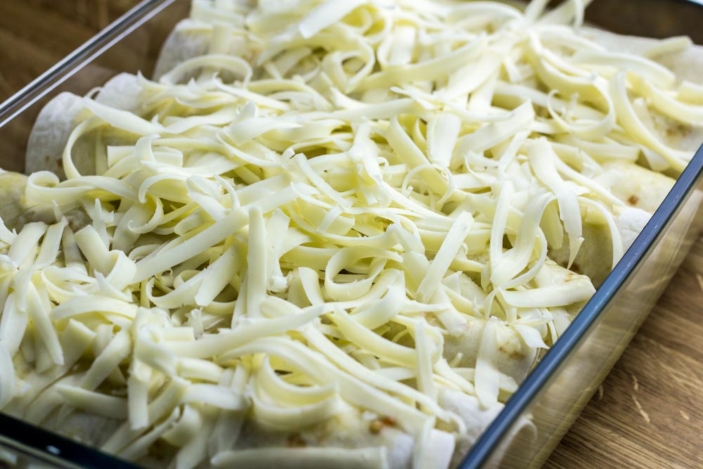 Shredded Monterey Jack Cheese Sprinkled Across Enchiladas