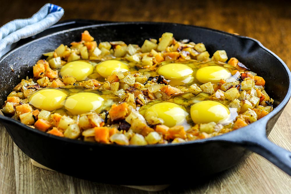 Raw Eggs Sitting in Potato Hash