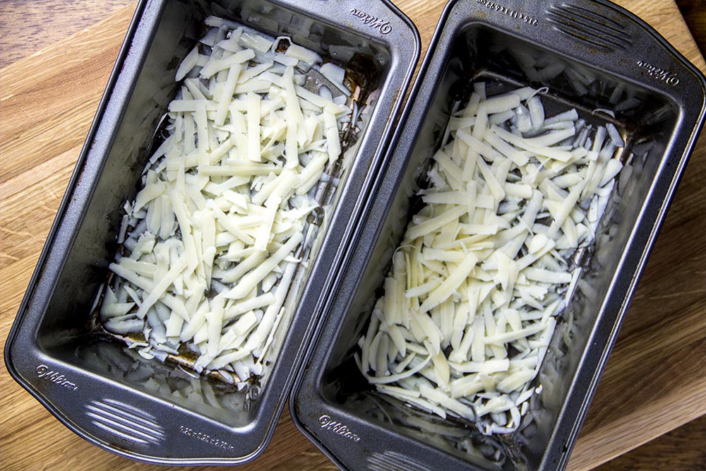 Shredded Parmesan at Bottom of Greased Bread Pans