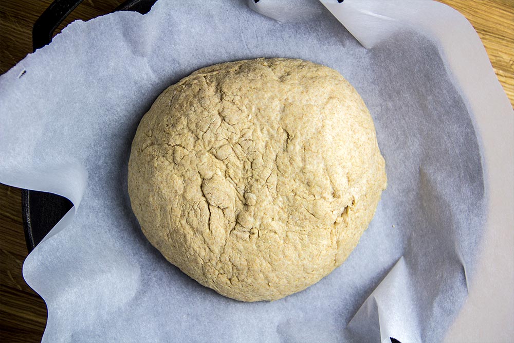 Bread Dough on Parchment Paper in Cast Iron Skillet