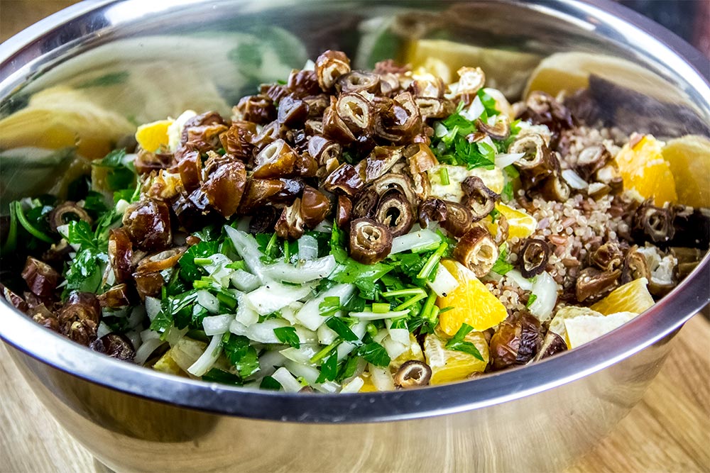 Orange and Date Salad Ingredients in Large Stainless Steel Bowl