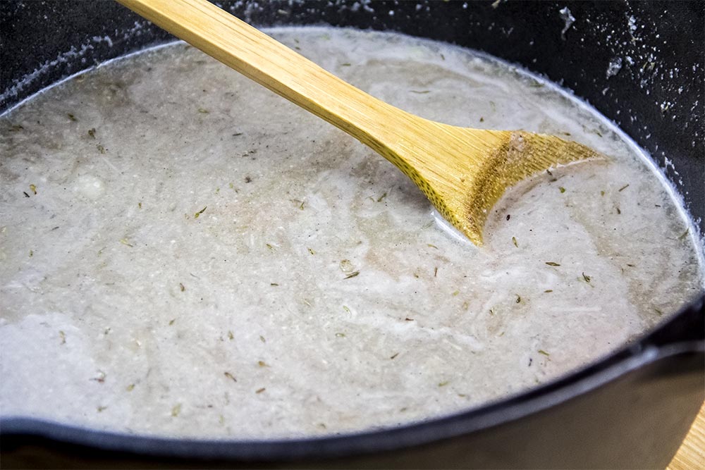 Adding Vegetable Broth to Soup Recipe in Lodge Dutch Oven