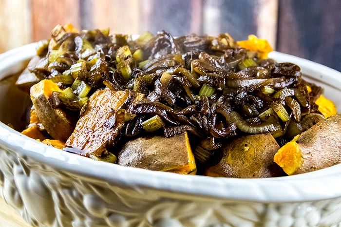 Onion Mixture Covering Potatoes in Casserole