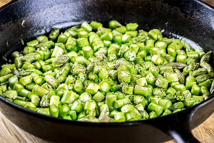 Cut Asparagus Pieces in Cast Iron Skillet
