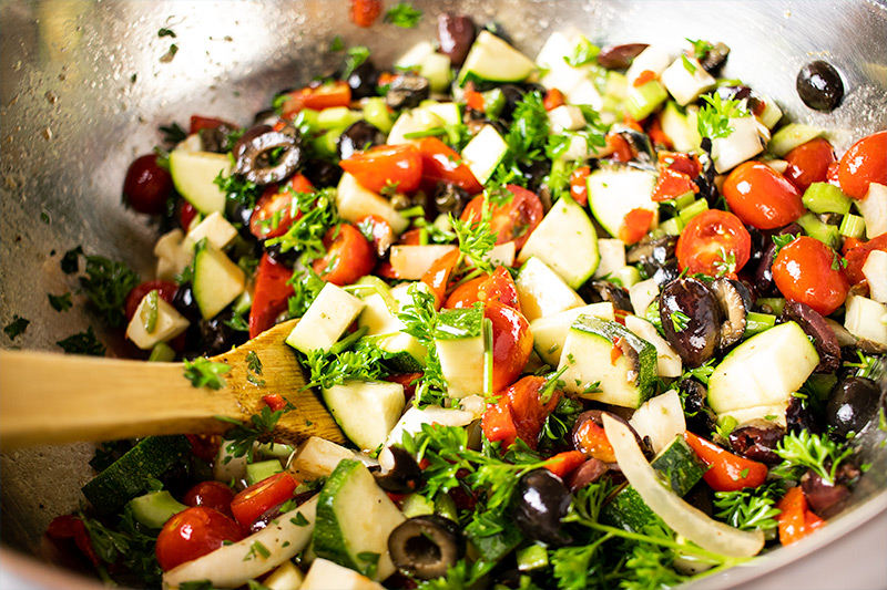 Mixing Pasta Salad Ingredients in Bowl