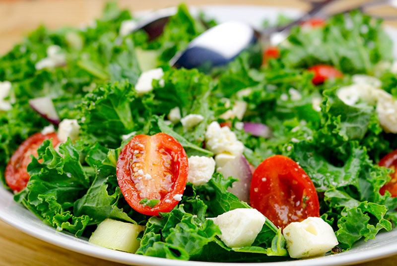 Kale Greek Salad In A White Bowl