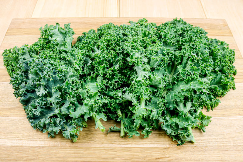 Fresh Garden Kale Set On A Cutting Board